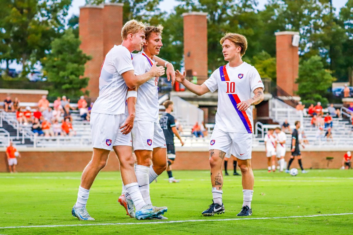 Clemson United teammates James Kelly, Jackson Wrobel and Alex Meinhard, regrouping on the field in their game versus Loyola on Sept. 11.