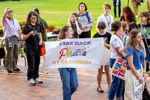 Several of those who participated in Wednesday's Take Back Pride march carried banners or signs promoting pride.