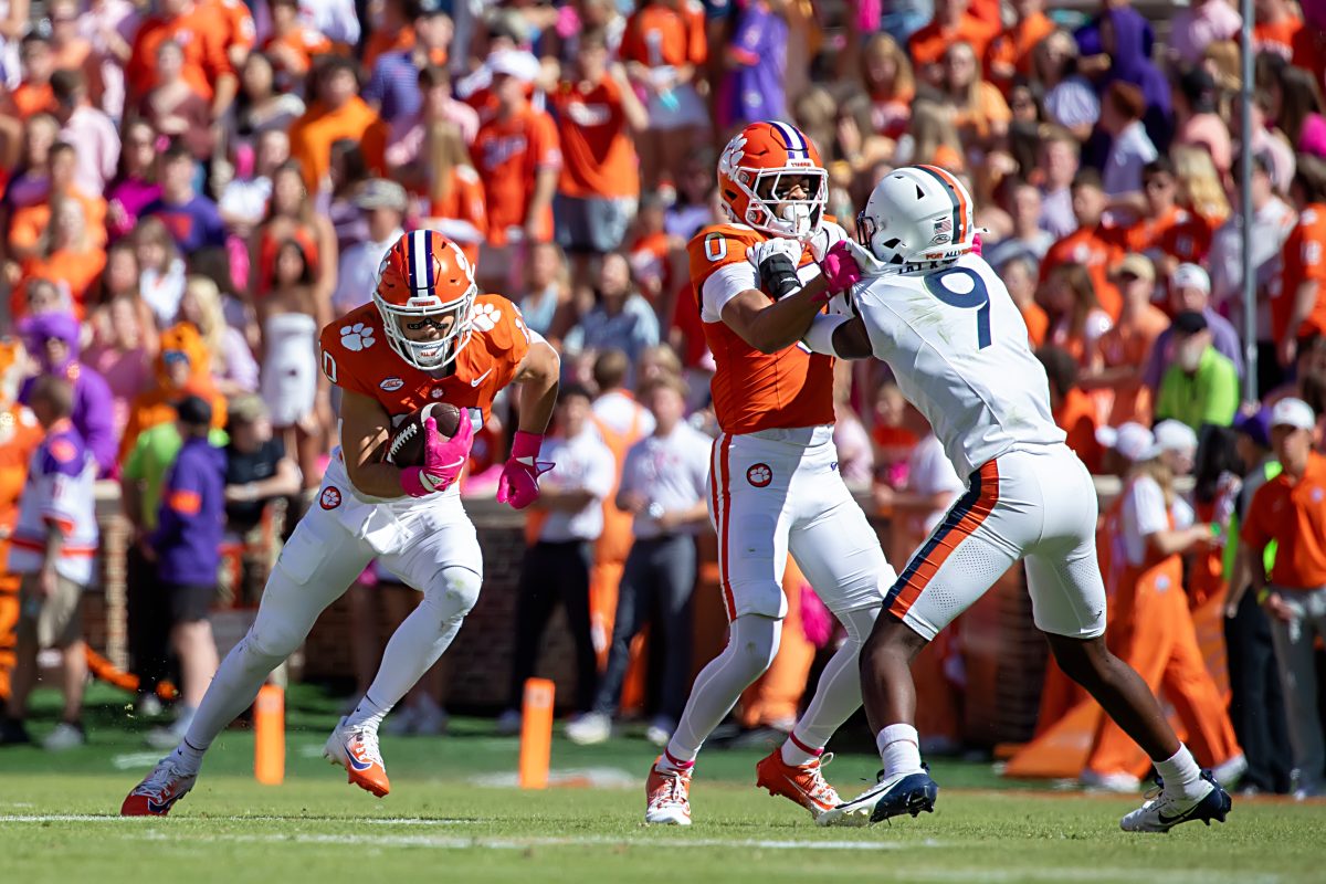 Against Virginia, offensive coordinator Garrett Riley incorporated the spread offense concept by creating favorable matchups in open space. Pictured is receiver Antonio Williams (0) blocking for Troy Stellato to run through.