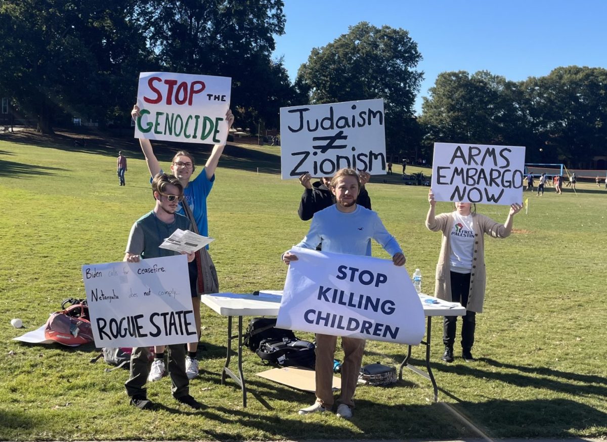 Students hold signs in favor of a ceasefire in Israel at a protest on Bowman Field on Oct. 18.