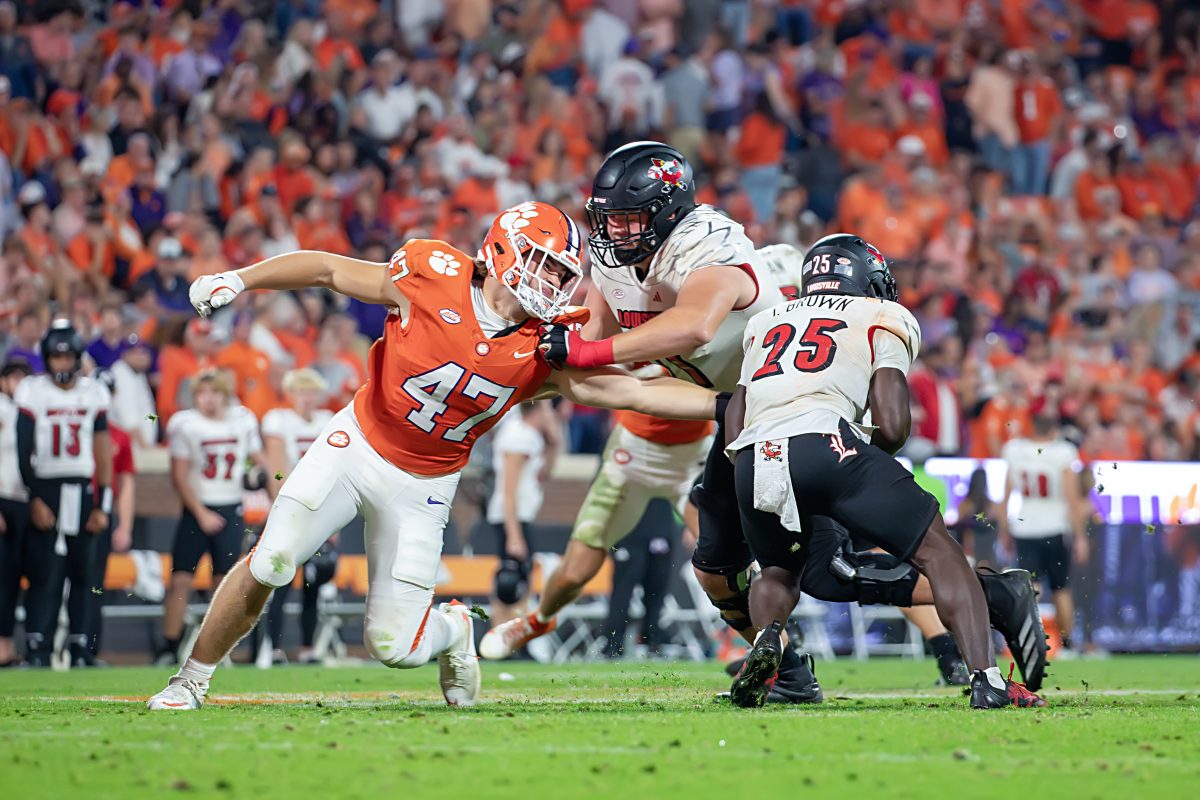 Linebacker Sammy Brown reaches for Louisville running back Isaac Brown during Clemson's game against the Cardinals on Nov. 2.