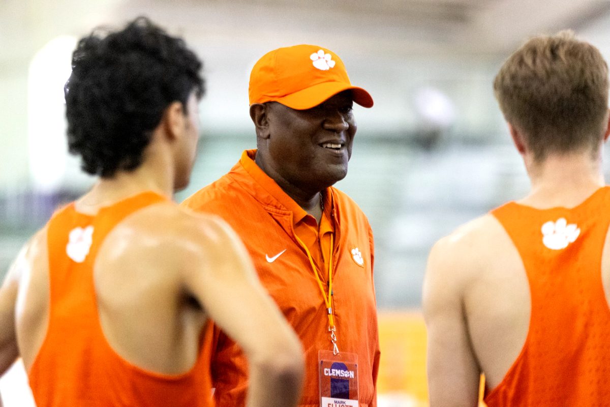 Mark Elliott, the director of track and field and cross-country, watches his team during the Bob Pollock Invitational on Jan. 26.