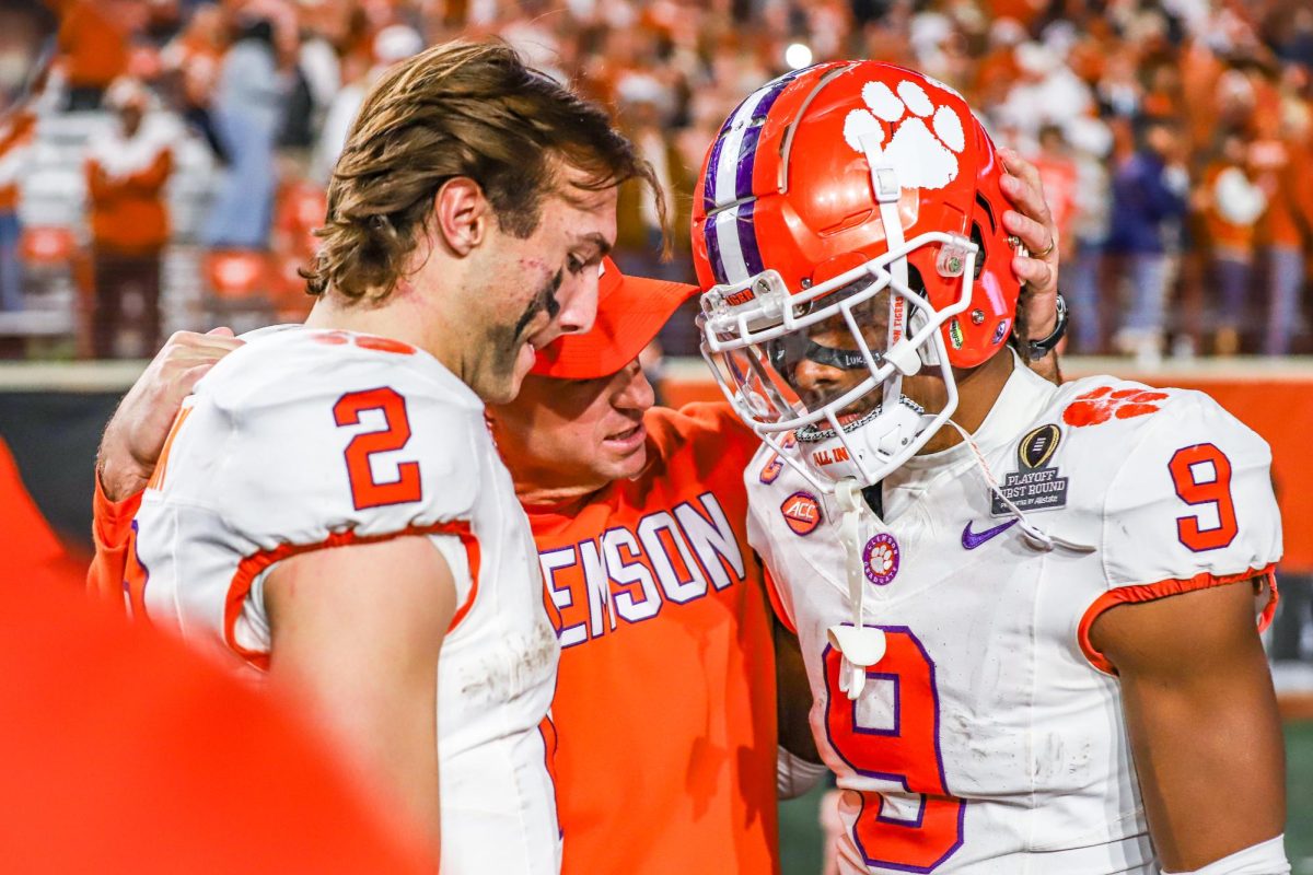 Head coach Dabo Swinney consoles quarterback Cade Klubnik (left), and safety RJ Mickens (right), after Clemson's loss to Texas in the first round of the College Football Playoff in Austin, Texas, on Dec. 21, 2024.