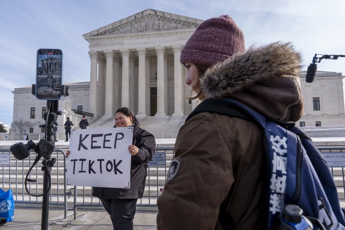 A small business owner from Columbia, South Carolina, protests the potential TikTok ban with a sign outside the Supreme Court in Washington, D.C., on Jan. 10.