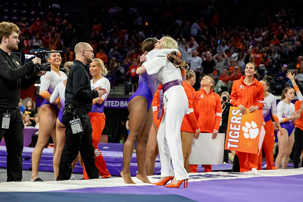 Head coach Amy Smith and Brie Clark embrace after a hard-fought win over Pittsburgh at Littlejohn Coliseum.