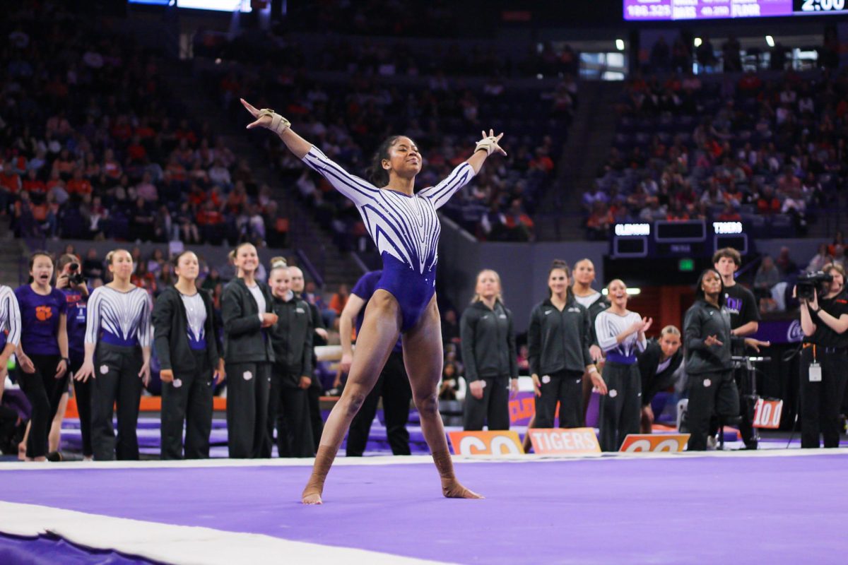 Eve Jackson performs a career-high floor routine as her team cheers her on.