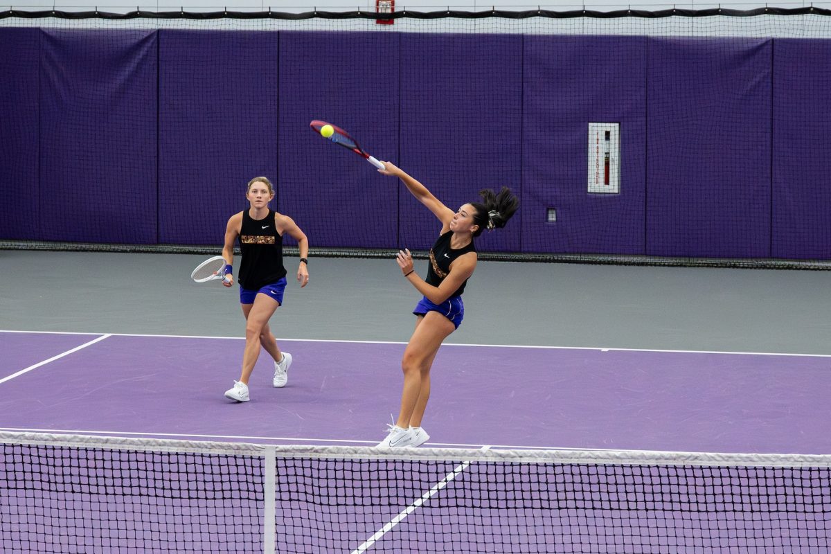 Graduate senior Sophia Hatton hits an overhand shot during Clemson's win over Kansas on Feb. 16 at the Duckworth Family Tennis Facility.