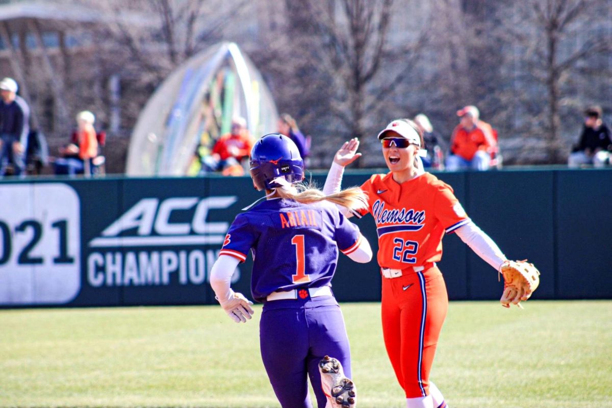 Taylor Pipkins high-fives outfielder Kennedy Ariail as she rounds the bases after hitting a solo home run in the bottom of the fourth inning.