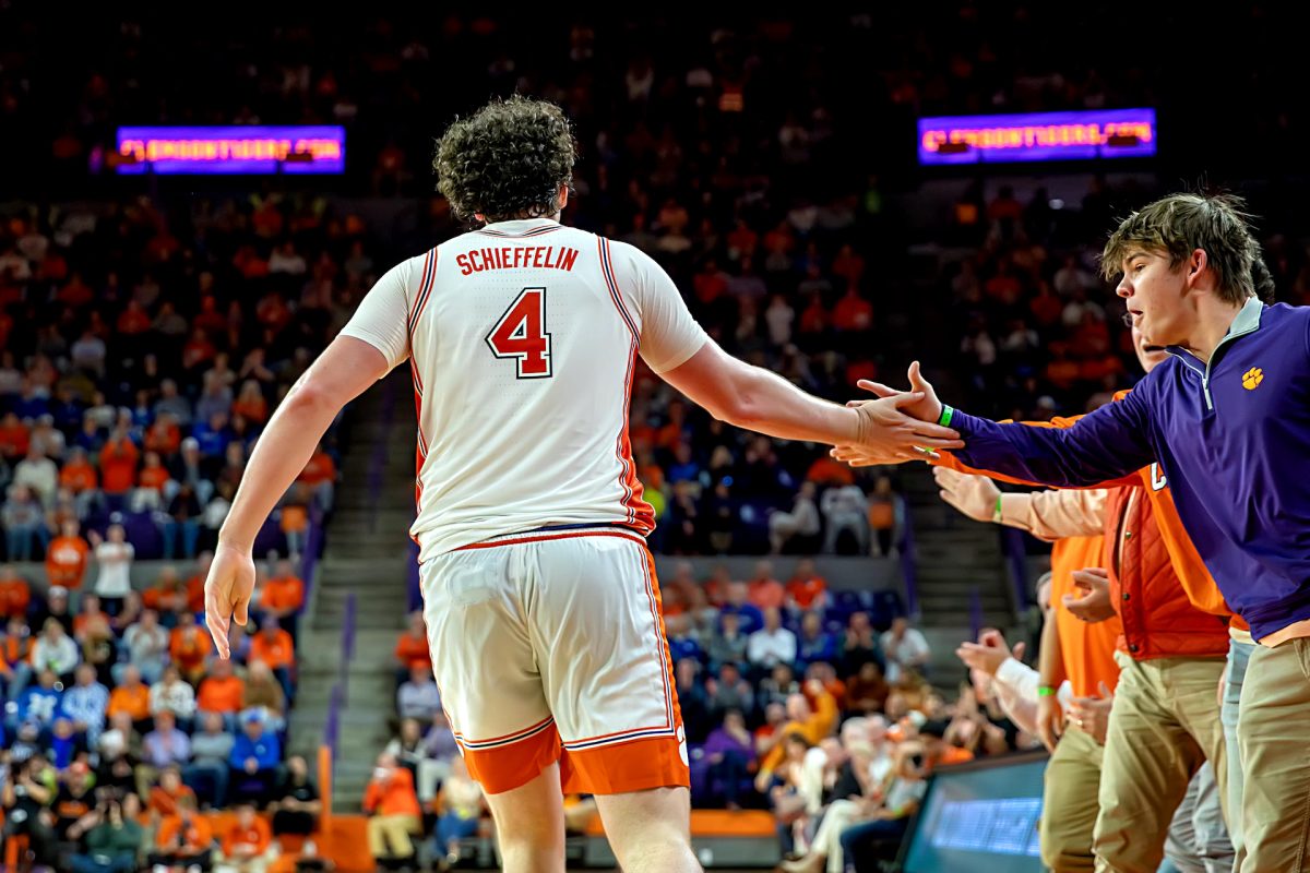 Clemson forward Ian Schieffelin high-fives students during the Tigers' win over Kentucky on Dec. 3, 2024, at Littlejohn Coliseum.