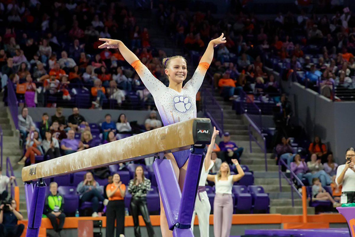 Lilly Lippeatt sticks landing after completing her beam routine against Pittsburgh at Littlejohn Coliseum.