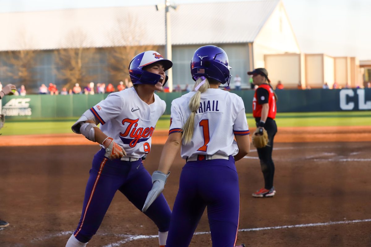 Clemson center fielder Jamison Brockenbrough (left) celebrates a scored run by Kennedy Ariail in the Tigers' win against Georgia at McWhorter Stadium on Feb. 26. 