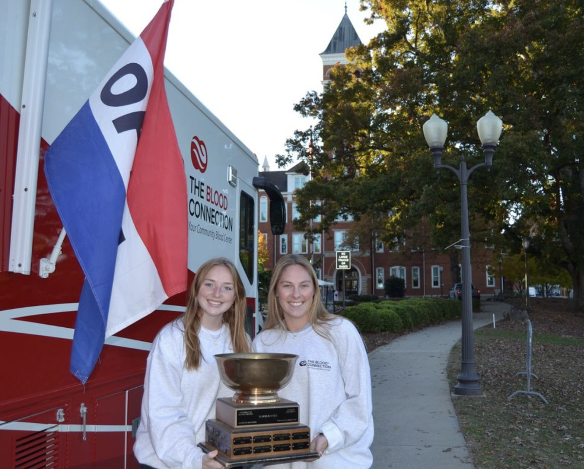 Clemson Blood Bowl cochairs Lindsey Schmidt and Caroline Graybeal pose proudly with the Blood Bowl trophy, one of Alpha Phi Omega's service programs.