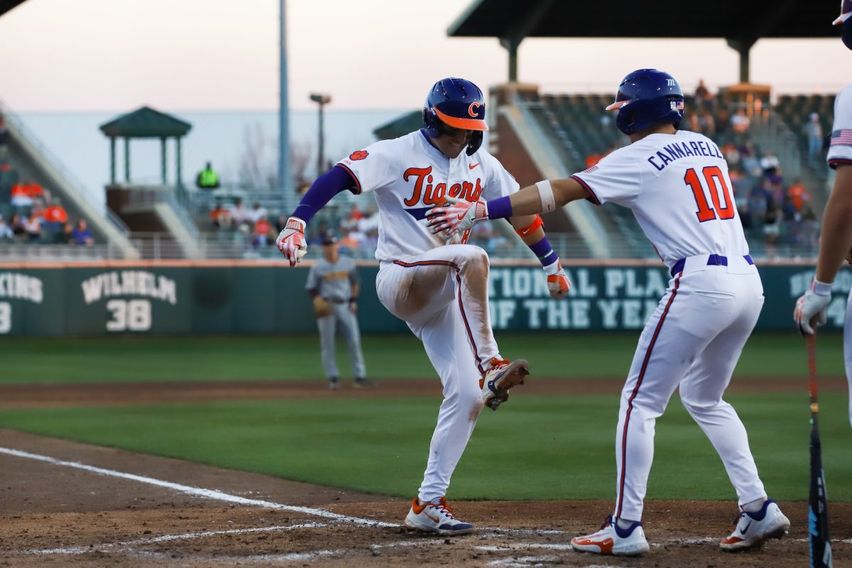 Clemson third baseman Josh Paino celebrates a home run with outfielder Cam Cannarella in the Tigers' win over Winthrop on Feb. 25 at Doug Kingsmore Stadium.