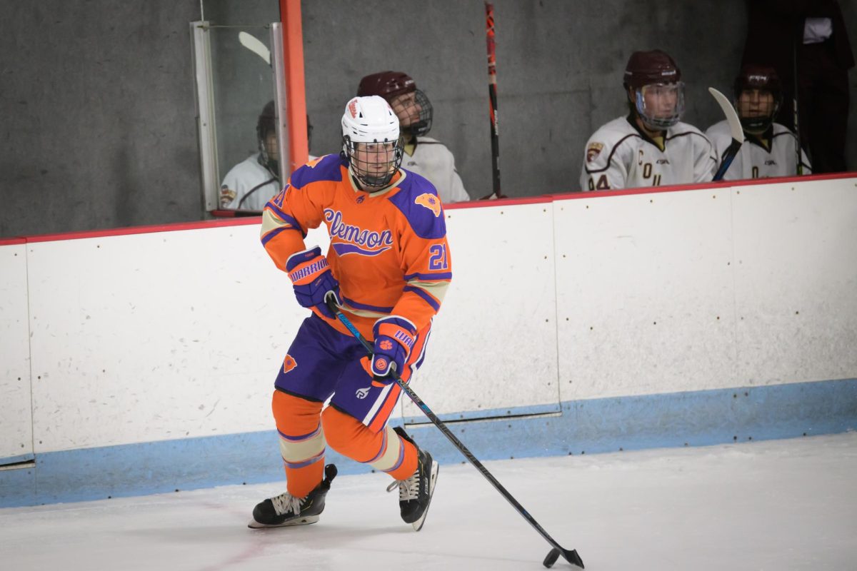 Defenseman Conor Peterson (21) skates the puck up the ice during Clemson's game against Charleston on Sept. 23, 2022.