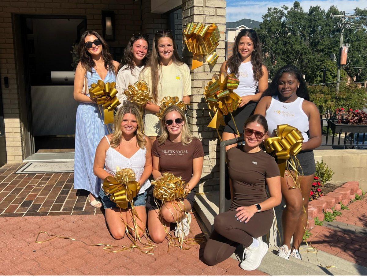 Clemson students, cheerleaders, business owners and local residents tied gold ribbons around downtown Clemson for Pediatric Cancer Awareness Month.