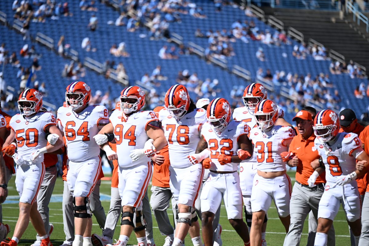 The Tigers link arms with each other and head coach Swinney moments before heading into the second half against UNC.