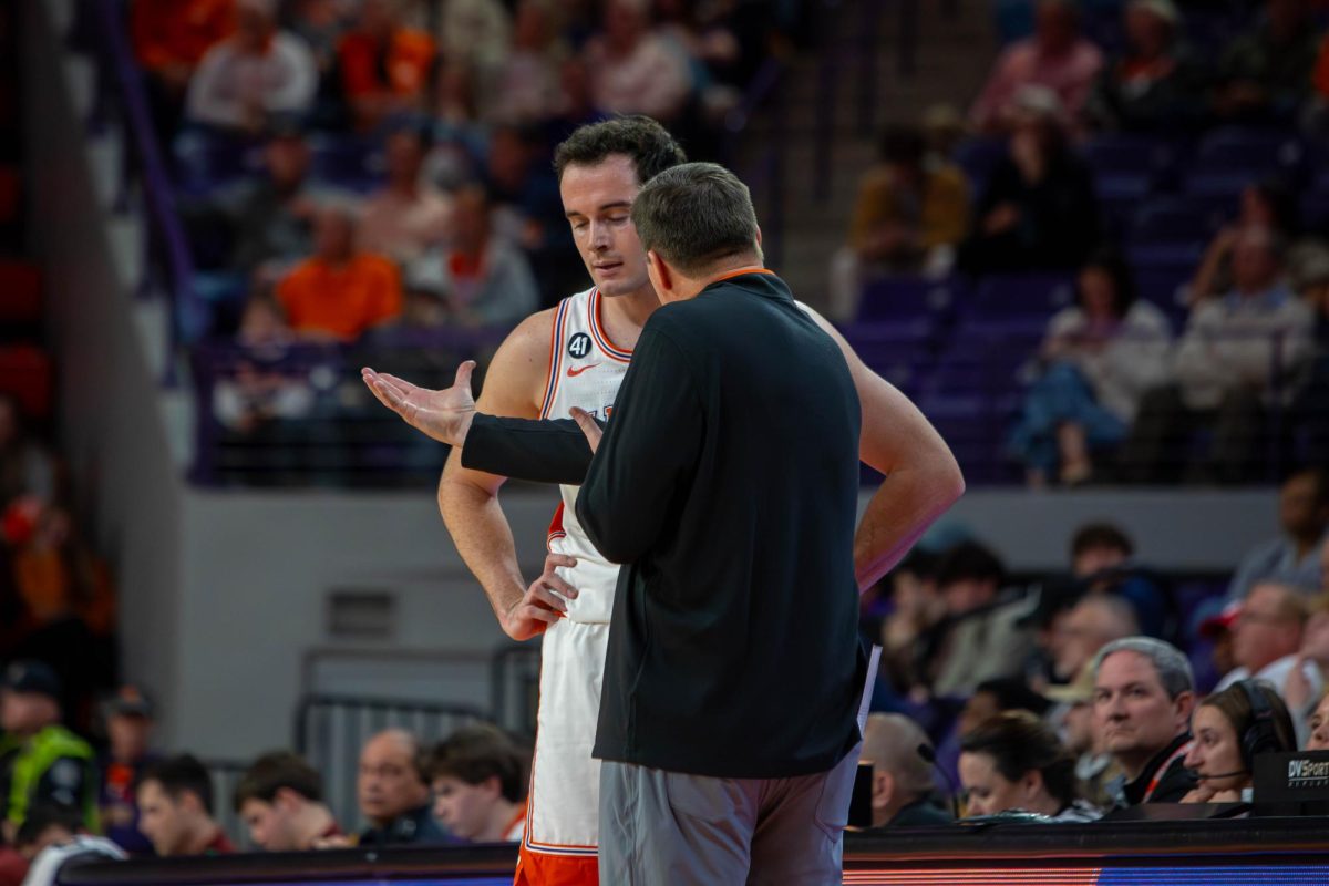 Head coach Brad Brownell speaks with Nick Davidson in a timeout during Clemson's game against Boston College.