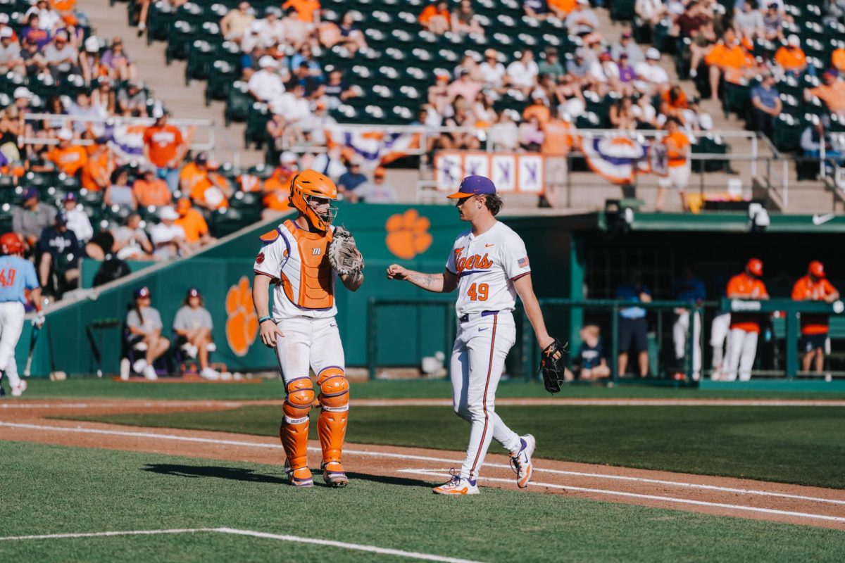 Pitcher Michael Sharman gives his catcher some love after a strikeout. 