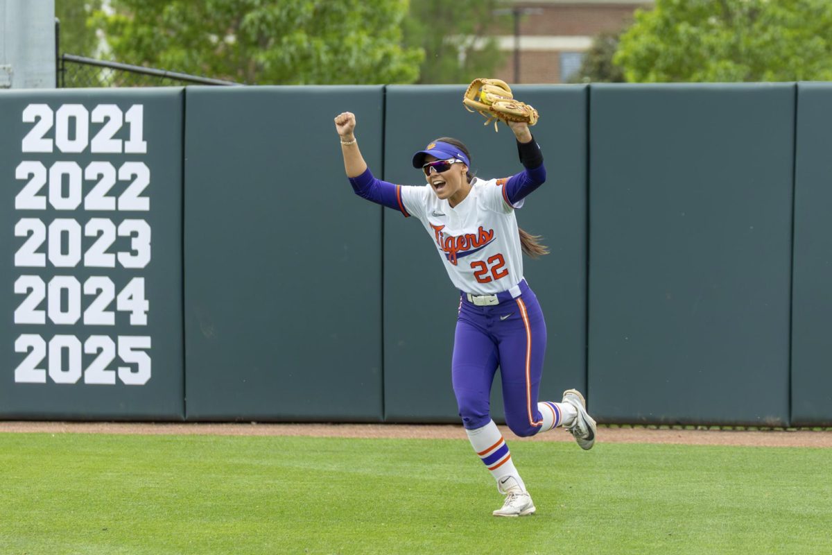 Taylor Pipkins holds her glove high, celebrating a big out in right field. 