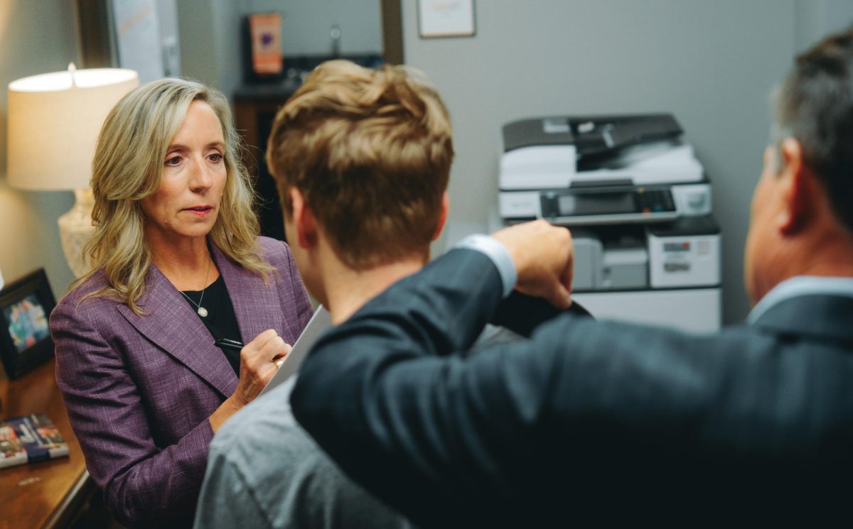 Kelly and Ward Carson work together to fit a ClemsonLIFE student for a custom jacket during a visit to Clemson in February.