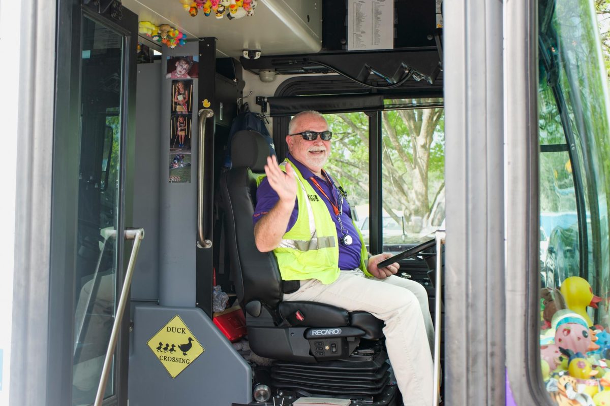 Mr. Lynn waves "hello" as he gets ready to drive the Blue Route.