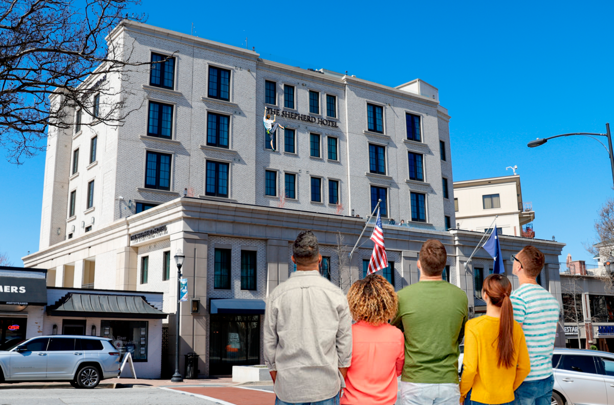 Onlookers watch in awe as an unidentified individual scales the Shepherd Hotel in downtown Clemson. 